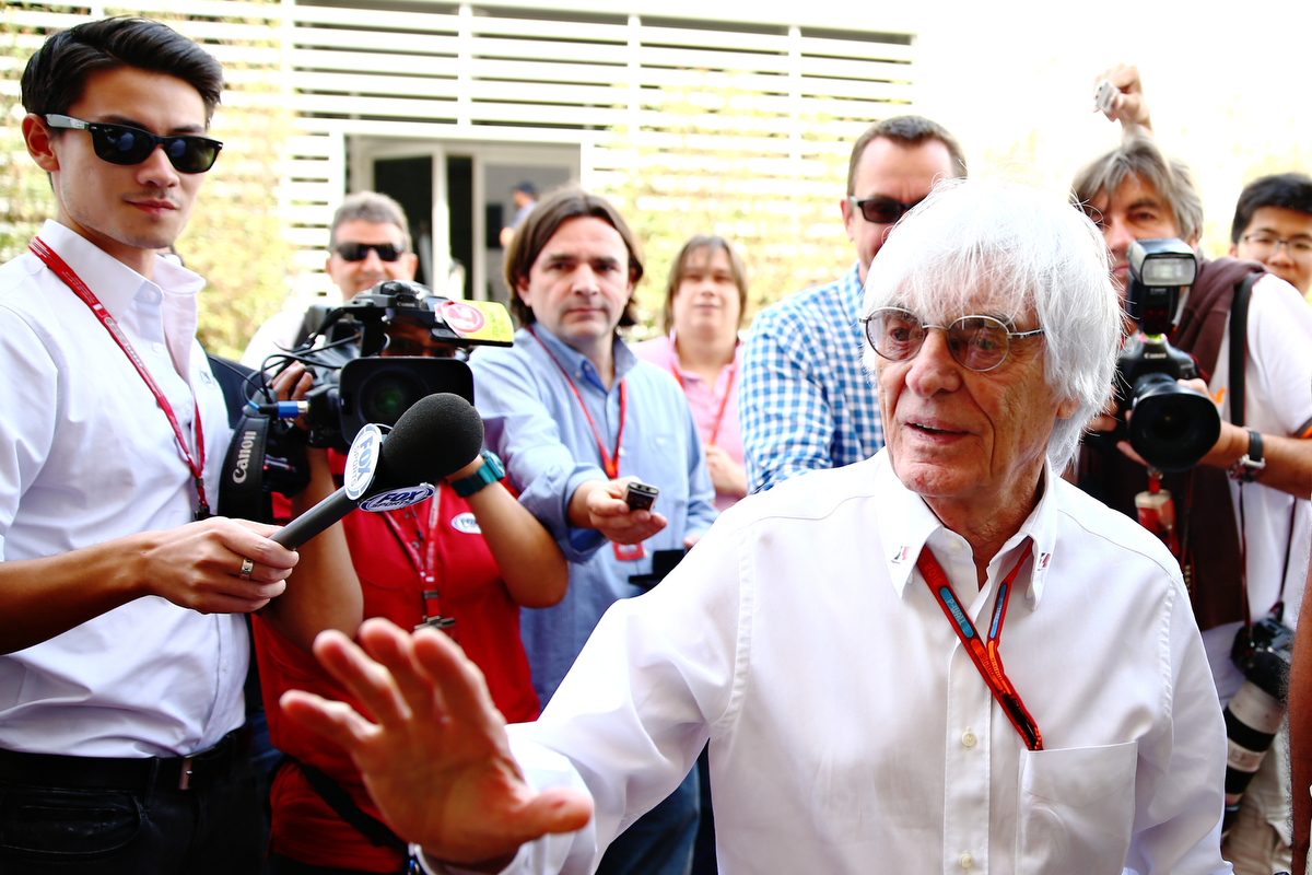 Bernie Ecclestone surrounded by photographers in the Paddock. Pic: Clive Mason/Getty Images