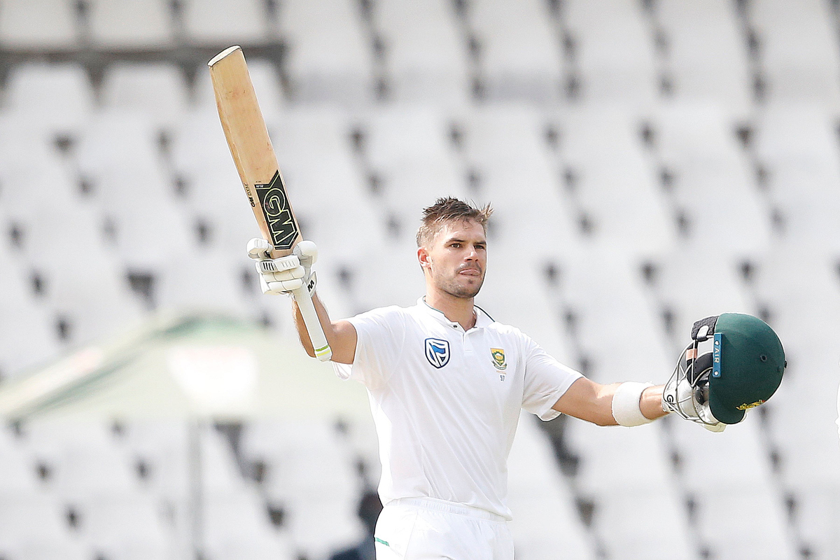 Rookie star Aiden Markram raises his bat and helmet as he celebrates scoring a century. Pic: GIANLUIGI GUERCIA/AFP/Getty Images.