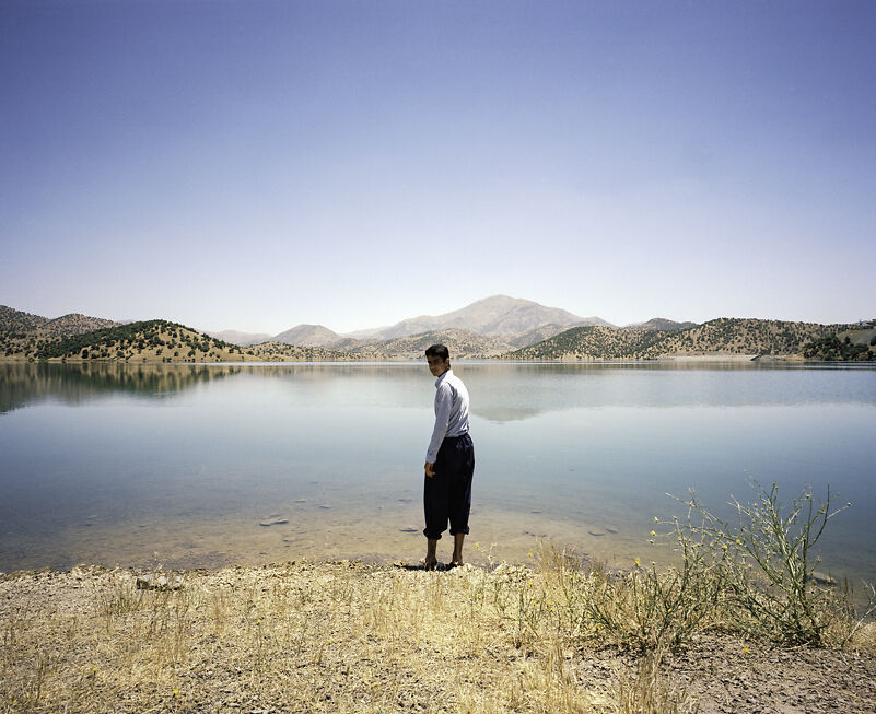Hehza preparing to wash before prayer whilst visiting the Garan Dam near Marivan, on the border of Iraq, Kurdistan