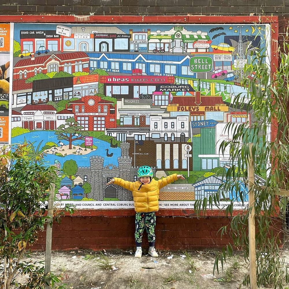 Laura's son Ruben poses with her large public artwork situated on the Upfield bike path, near the Coburg train station.