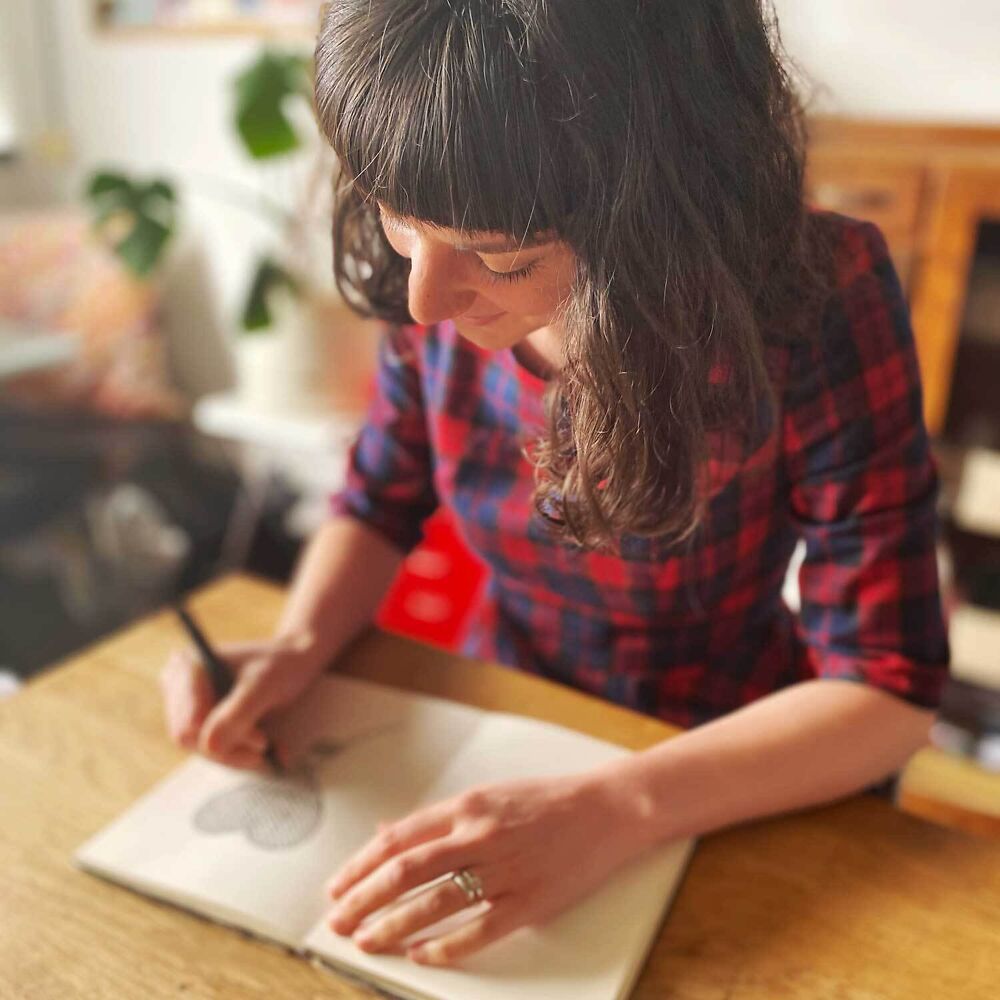Artist Emily May at work on a new illustration