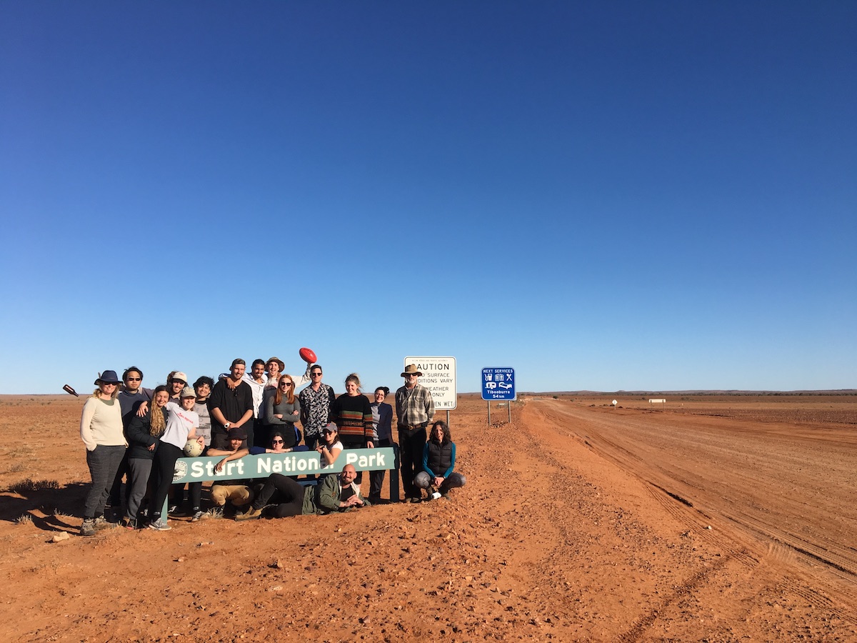 the group at Sturt National Park, blue sky above and red soil below