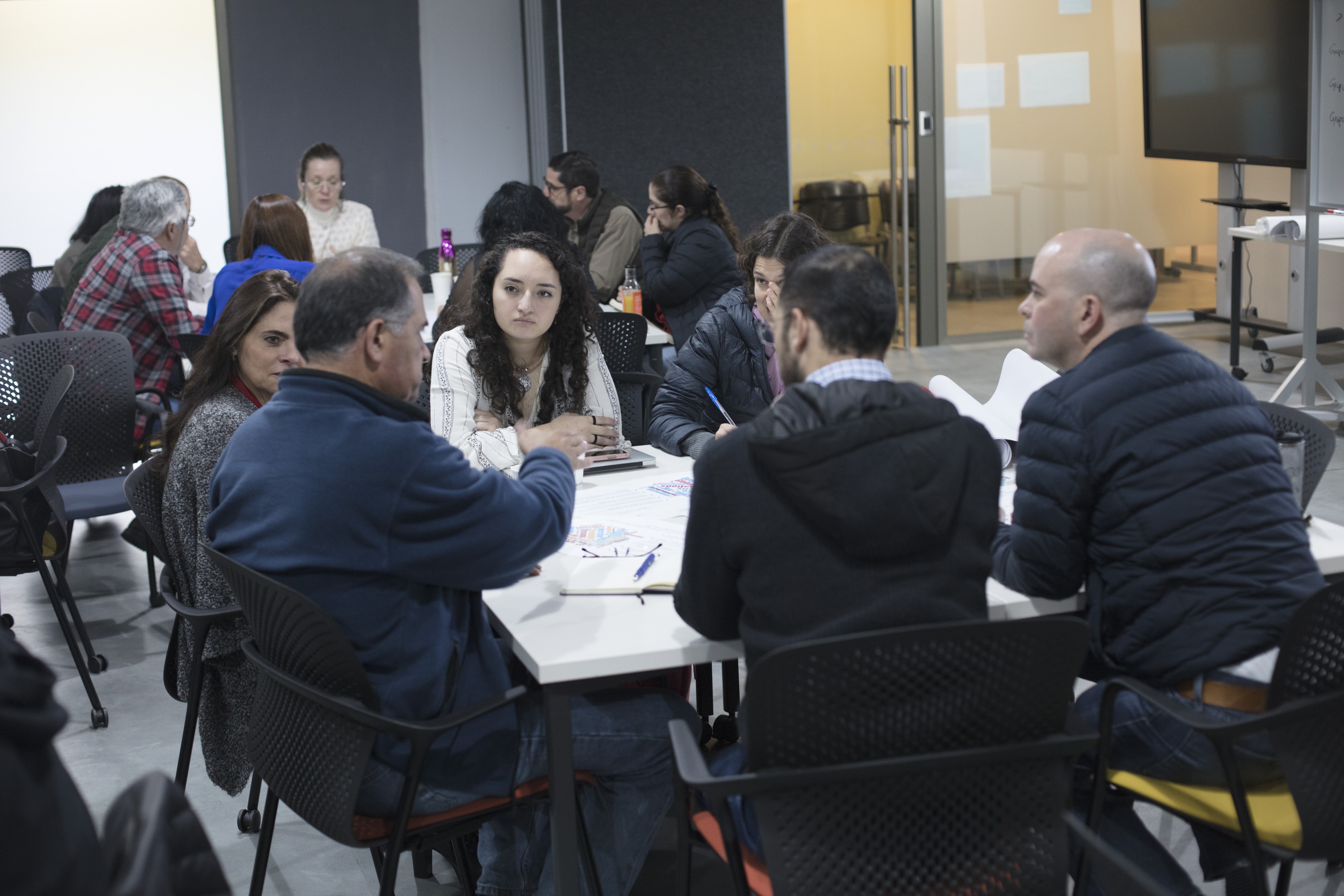 small group of people sitting around a table working together