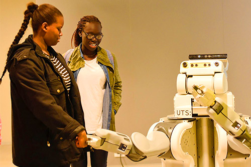 Two female students learn about social robotics Two female students learn about social robotics