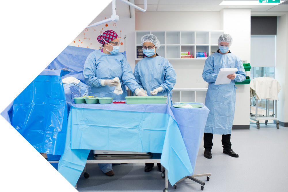 Students in scrubs counting and recording surgical instruments