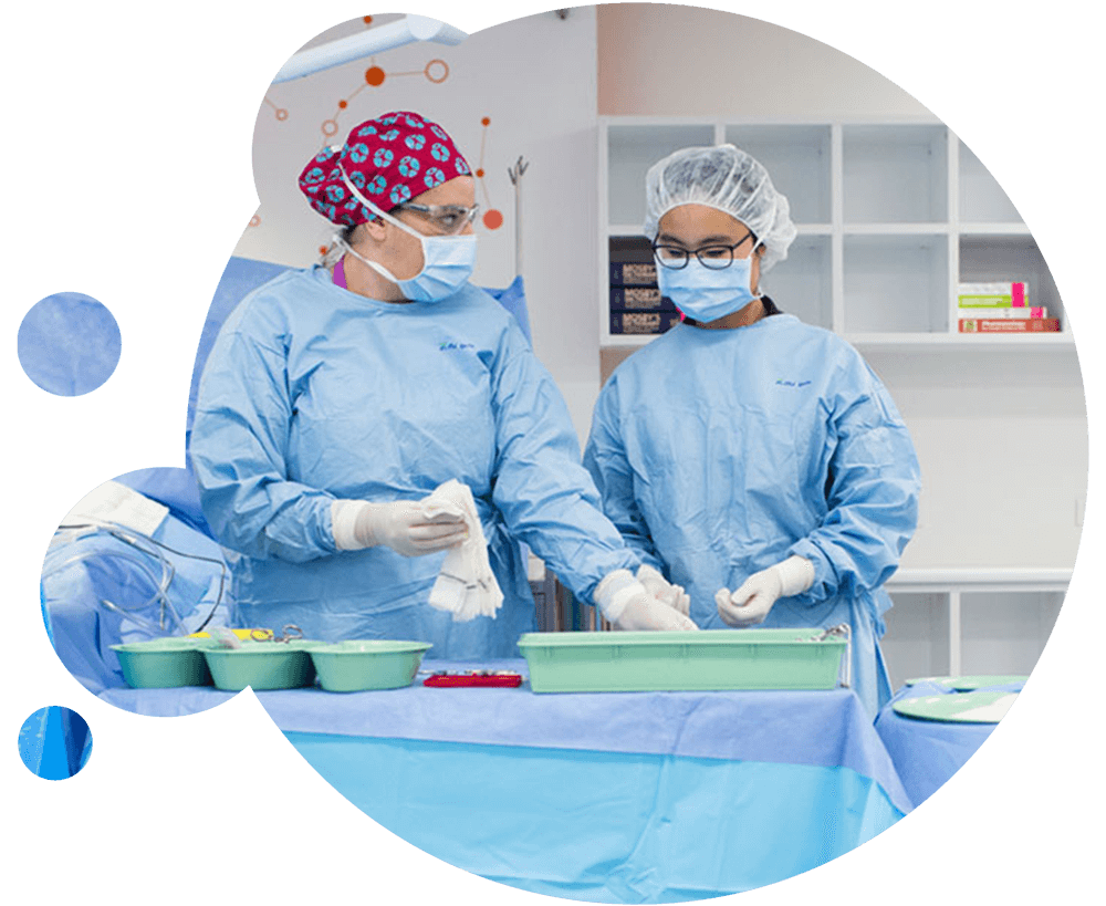 Students in scrubs counting and recording surgical instruments