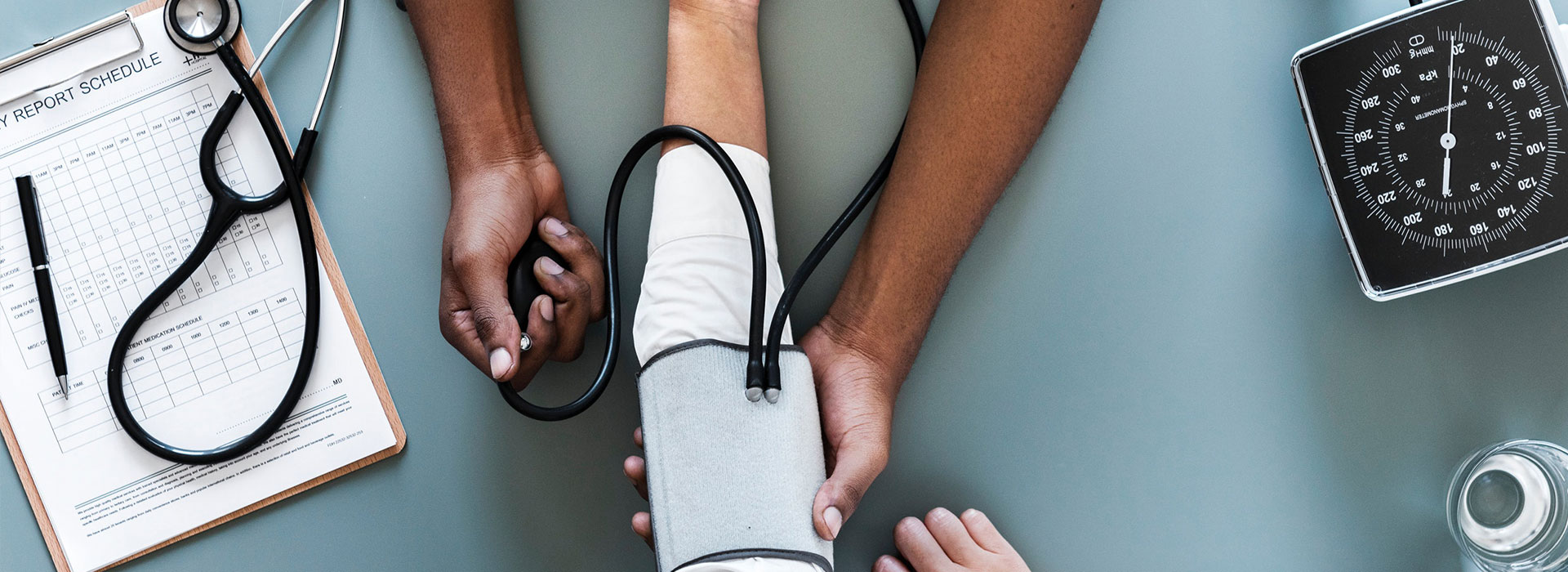 A nurse checking a patients blood pressure.