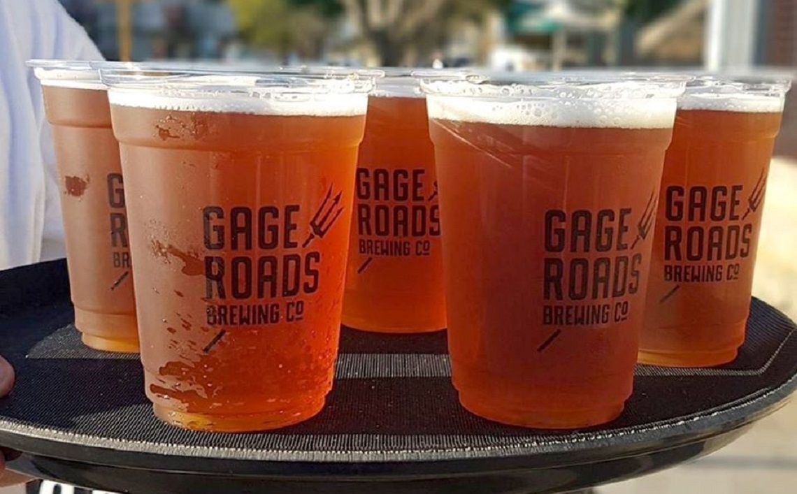 Gage Roads backs Good Drinks Strategy for future growth Tattooed bartender adding a bitter to the delicious cocktail from the special dasher bottle on the bar counter on the blurred background