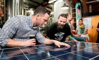 Young Henrys to become fully solar powered Sydney - October 23, 2015: Jake Steele (l) of Solargain and Oscar McMahon of Young Henry's with a solar panel inside the Young Henry's brewery. Solar panels are to be installed on the brewery roof as part of a community solar project (photo by Jamie Williams/City of Sydney)