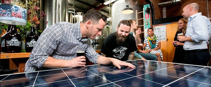 Young Henrys to become fully solar powered Sydney - October 23, 2015: Jake Steele (l) of Solargain and Oscar McMahon of Young Henry's with a solar panel inside the Young Henry's brewery. Solar panels are to be installed on the brewery roof as part of a community solar project (photo by Jamie Williams/City of Sydney)