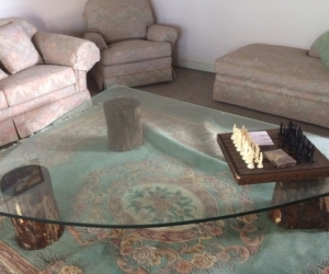 Large coffee table, antique glass on treated redwood stumps