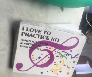 Suzuki cello practice kit and bib