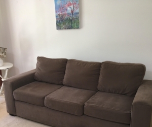 Fawn coloured large couch with Ottoman