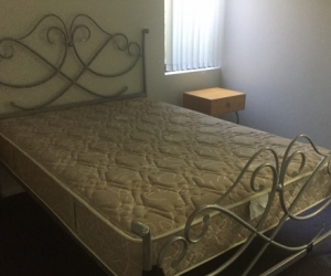 Steel double bed with a mattress
