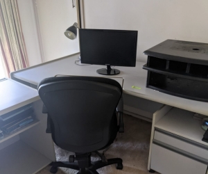Corner desk with set of drawers and stationary drawers
