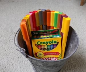 Textas and crayons in bucket